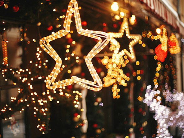 blurred photograph of outdoor festive Christmas star light decorations in a Christmas market 